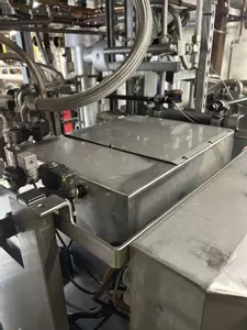 Top view of custom stainless steel replacement tank installed on a Nilfisk Delta Booster multi-pump pressure washer system.